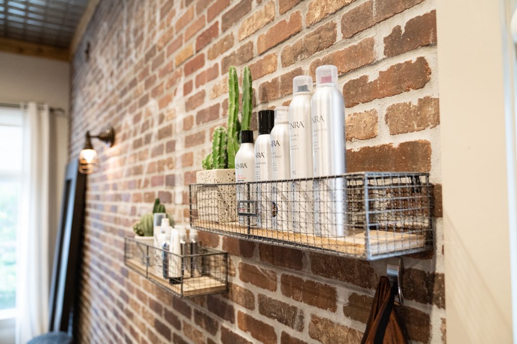 Retail display of Olaplex, K18, and Wella professional hair products available at Salon 221 in Jupiter, FL.